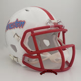 A white Houston Cougars football helmet with a red faceguard and red stripe on the crown, featuring the Houston wordmark in red and blue on the side. A tribute to the Houston Oilers.