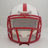 A white Houston Cougars football helmet with a red faceguard and red stripe on the crown, featuring the Houston wordmark in red and blue on the side. A tribute to the Houston Oilers.