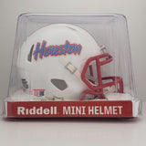 A white Houston Cougars football helmet with a red faceguard and red stripe on the crown, featuring the Houston wordmark in red and blue on the side. A tribute to the Houston Oilers.