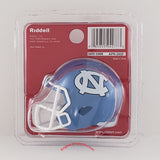 Riddell pocket size helmet in its original blister packaging, featuring a miniature blue and white UNC Tar Heels football helmet.